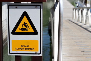 The warning sign beware slippery at the gangway or gangplank