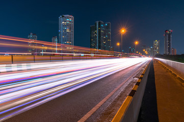 Fototapeta na wymiar Light trails on the modern city street at night