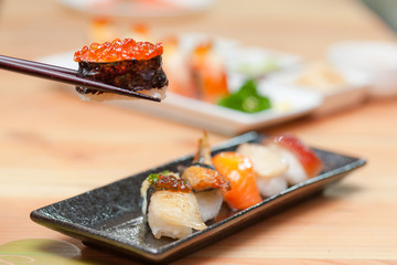 Sushi with chopsticks.