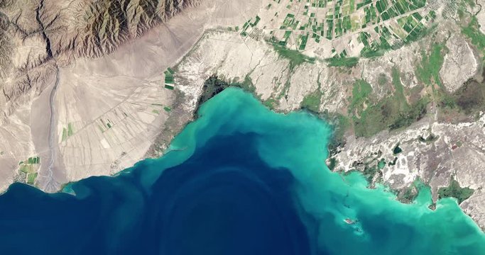 High-altitude overflight aerial of a mountain valley lake in Kazakhstan&rsquo;s Almaty province. Clip loops and is reversible. Elements of this image furnished by NASA