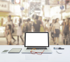 Blank screen laptop computer with blurred image of crowded people with retro color effected