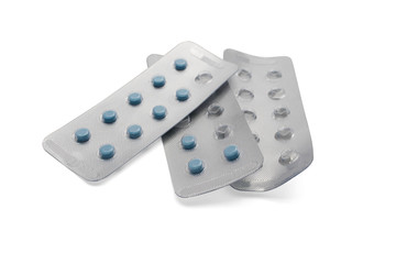 Blue pills in packages and empty packages isolated on white background