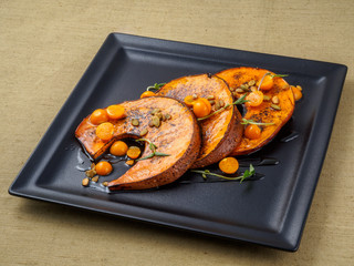 Baked pumpkin with winter cherry and rosemary.