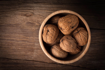 Walnuts in wooden bowl.