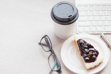 Disposable coffee cup with blueberry chess pie.