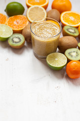 Smoothie rich in vitamin C made with oranges, lemons, limes, clementines, kiwis, copy space for text, selective focus