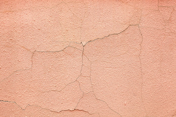 Cracks on the pink cement plaster