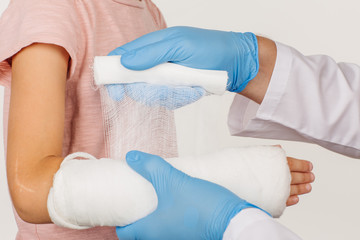 doctor bandaging hand of little patient. medicine, health care a