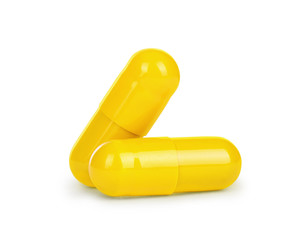Close-up two yellow medical capsules isolated on white backgroun