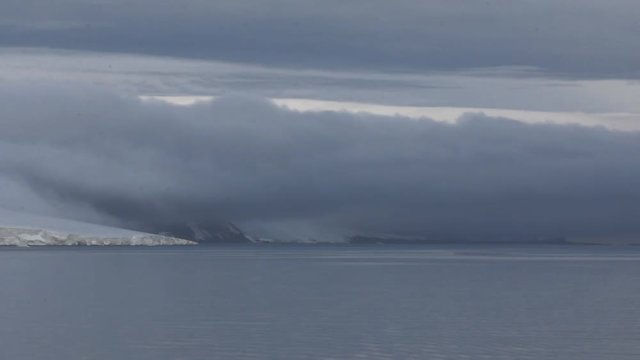 Harsh Arctic. Huge dark cloud slides from glacier. Island Ziegler. Franz-Joseph Land
