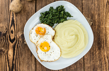 Mashed Potatoes with spinach and fried egga (selective focus)