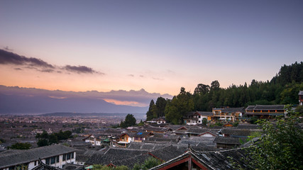Top View of traditional roof with sunrise and dramatic effects at The Old Town of Lijiang is a...