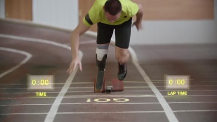 Disabled athlete with artificial leg starting from blocks and running towards the camera in slow motion. Holographic animations calculating lap and overall times  - Powered by Adobe