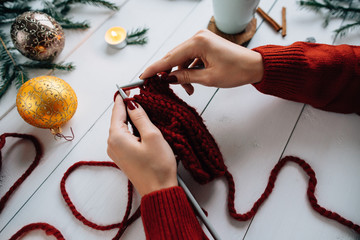Christmas composition. Hot chocolate, knitting , candles, fir sprigs, Christmas lights. 