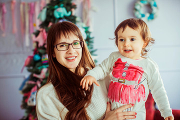 beautiful portrait of cute little girl and her happy mother