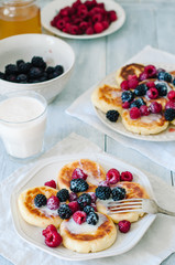 Breakfast with homemade cottage cheese pancakes with with berries and condensed milk