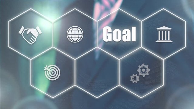 Businessman pressing a Business Goal concept