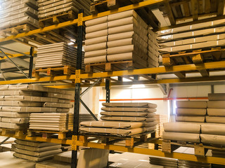 Interior of a large modern warehouse. Warehouse with rows of pallets with cartons of products import export. Goods in boxes of pallets in distribution logistics industrial warehouse before shipment.