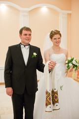 Wedding couple holding hands with rings, bride and groom on ceremony.