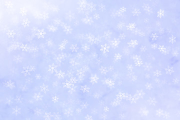 Abstract winter background with snow flakes falling.