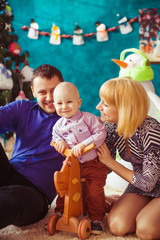 mom and dad playing with their baby son