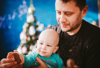 Dad with his son in a studio Christmas.