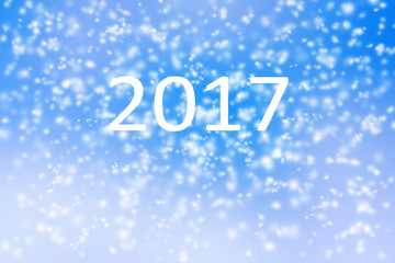 Happy new year 2017 background of blurred snow storm on blue sky