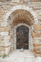 old iron door in a stone wall
