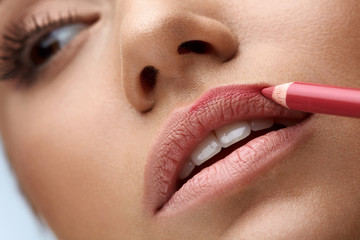 Face Makeup. Beautiful Woman Using Lip Pen, Pencil For Lips