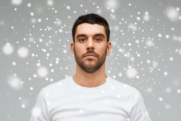 young man portrait over snow background