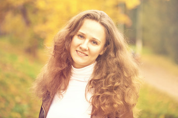 Young beautiful woman in autumn park