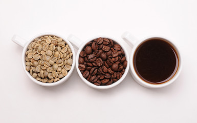 Fototapeta premium Three white cups with different stages of coffee: green and roasted beans and ready drink
