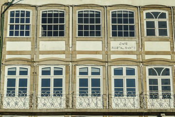 Fototapeta premium traditional large windows of a building in the square of the Toural of Guimaraes's town, Portugal