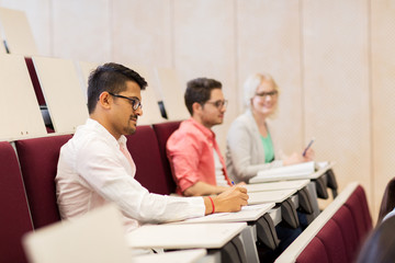 group of students with notebooks in lecture hall