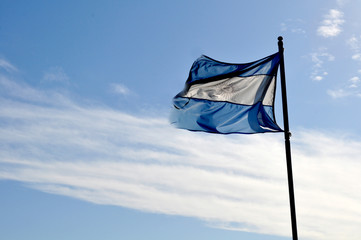 Argentina flag waving on a sunny day against blue sky