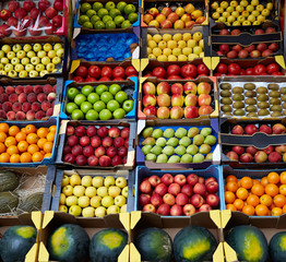 Fruits background in boxes display at market