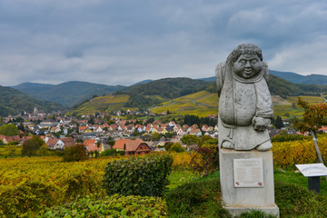Andlau, Alsace village, vineyard, statue of monk carrying wine barrel