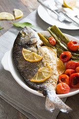 Baked fish with asparagus and cherry tomatoes