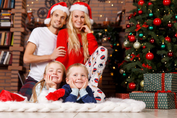 Fototapeta na wymiar Family in sleepwear on Christmas