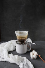 Fototapeta na wymiar cup of black steaming coffee espresso with preparing set