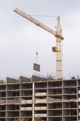 Crane raised formwork on construction of multi-storey residential building