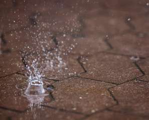 Rain on asphalt or tarmac road creating ripples