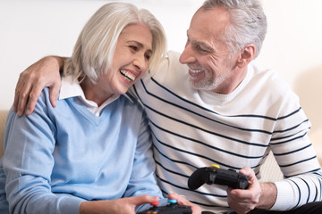 Cheerful aged couple relaxing at home