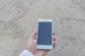 Businessman using his Mobile Phone outdoor, close up
