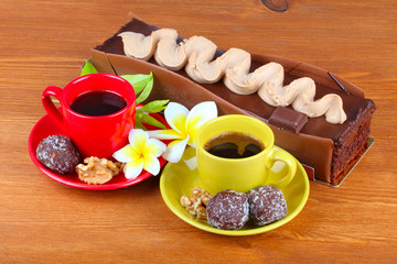 chocolate cake with two cup of coffee and chocolate balls