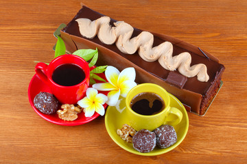 Fototapeta na wymiar chocolate cake with two cup of coffee and chocolate balls