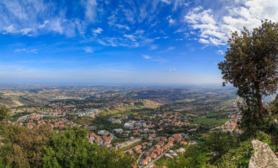 View of San Marino from Monte Titano, summer day, blue sky, light clouds