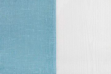 Sack from left sidewhite  wooden table.
Soft blue woven linen fabric texture / wood texture....