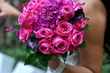 Holding beautiful bouquet of pink roses