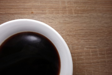Hot coffee in a mug, macro view, copy space